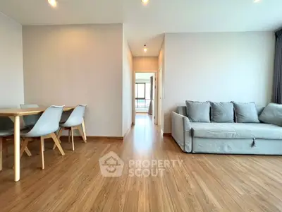 Spacious modern living room with wooden flooring and stylish furniture