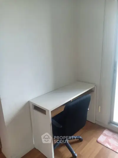 Cozy study nook with desk and chair by a window, perfect for focused work or study sessions.
