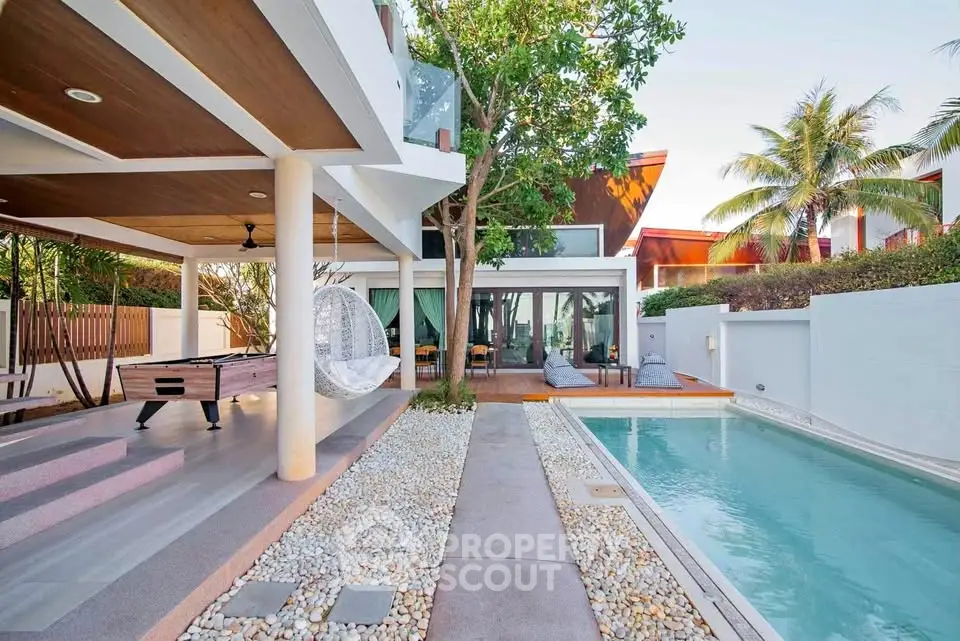 Luxurious modern villa with private pool and outdoor lounge area, perfect for relaxation and entertainment.