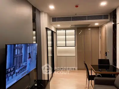 Modern living room with sleek design, featuring a wall-mounted TV and stylish dining area.