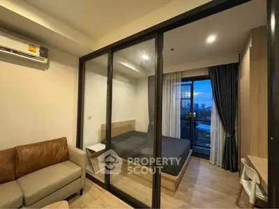 Modern studio apartment with glass partition and city view balcony