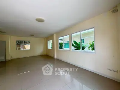Spacious empty living room with large windows and natural light