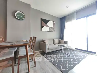 Modern living room with stylish decor, featuring a cozy sofa, dining set, and large window for natural light.