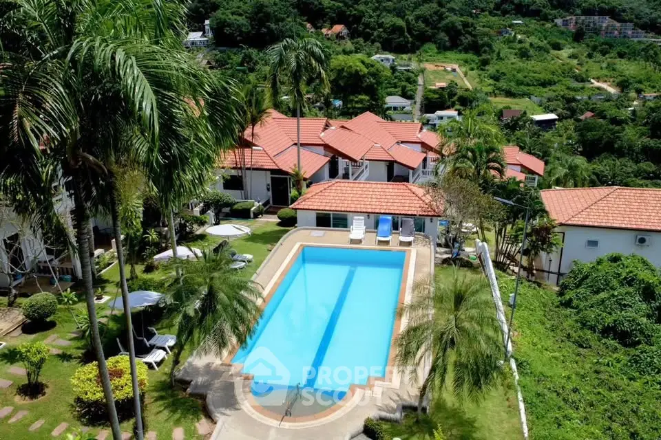 Stunning aerial view of a tropical resort with pool and lush greenery