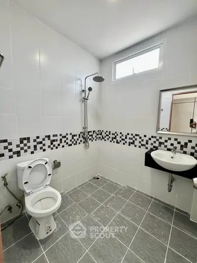 Modern bathroom with sleek tiles and contemporary fixtures