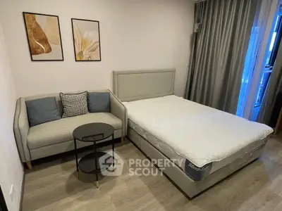 Modern bedroom with stylish decor, featuring a cozy bed and elegant sofa, perfect for relaxation.