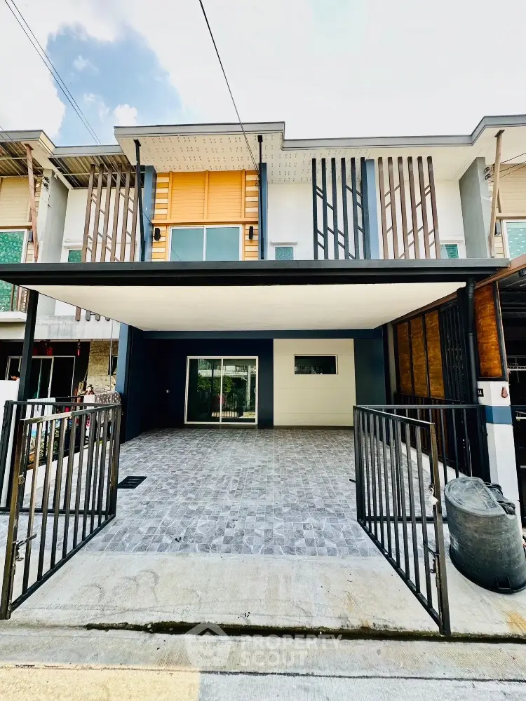 Modern townhouse exterior with spacious driveway and sleek design