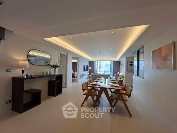Spacious modern living and dining area with elegant decor and city view.