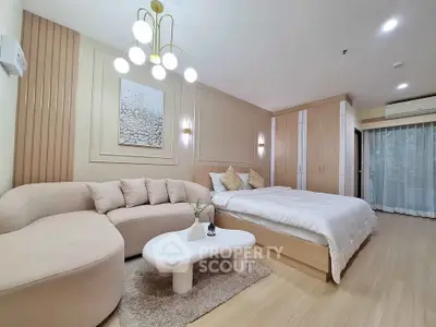 Luxurious modern bedroom with elegant decor and cozy seating area