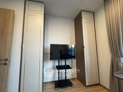 Modern living room with sleek TV stand and tall cabinets