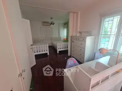 Charming children's bedroom with twin beds and study area, perfect for a cozy family home.