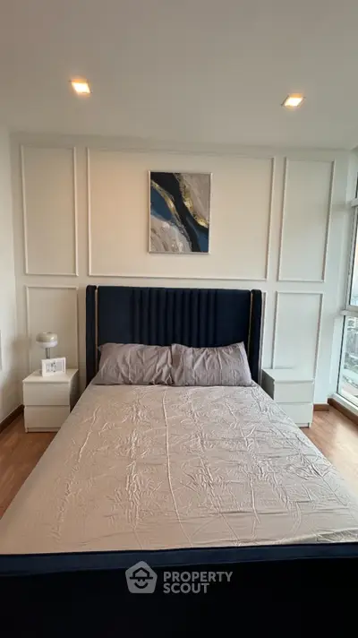 Modern bedroom with stylish decor and natural light