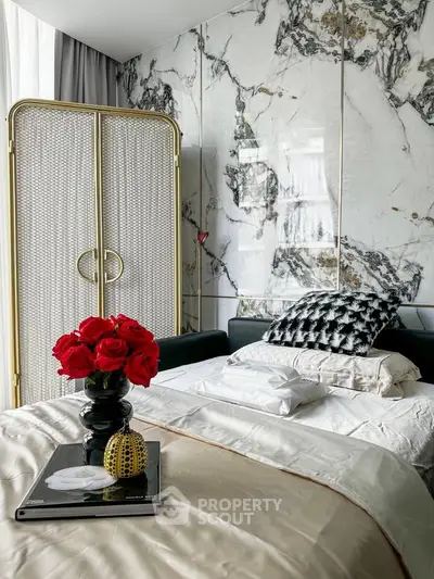 Luxurious bedroom with marble accent wall and elegant decor