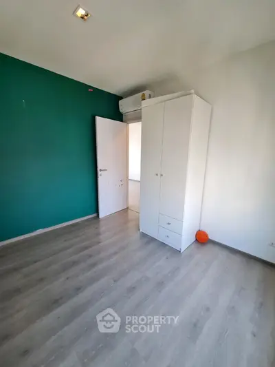 Spacious bedroom with modern wardrobe and air conditioning unit