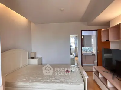 Spacious bedroom with ensuite bathroom and modern furnishings in a stylish apartment.