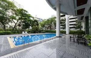 Luxurious outdoor pool area with modern design and lush greenery.