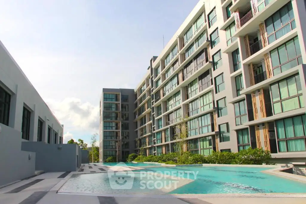 Modern apartment complex with pool and spacious balconies