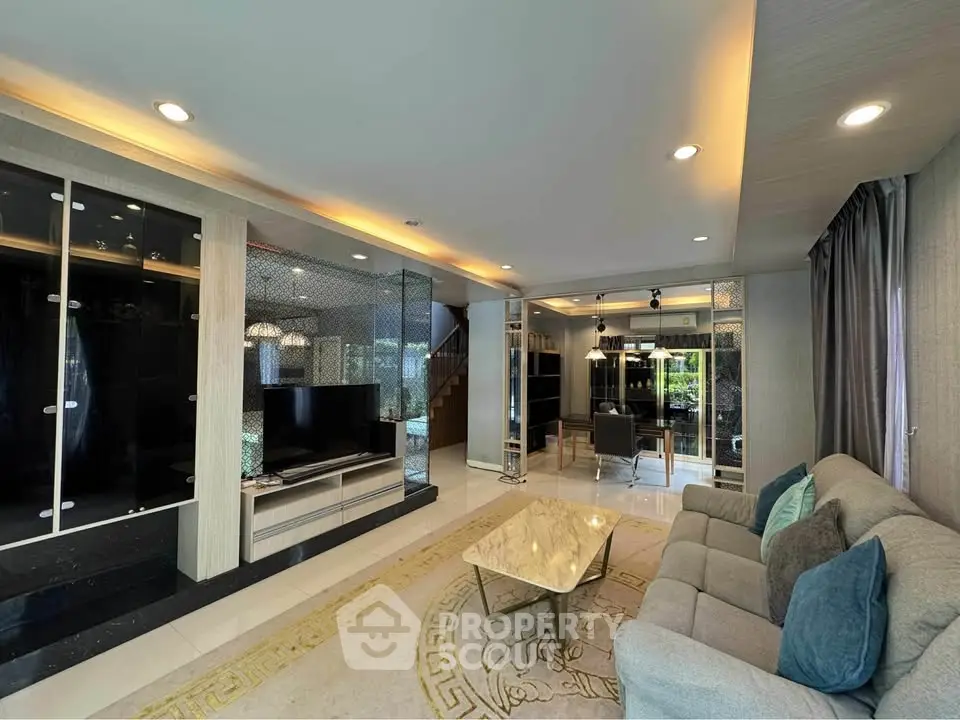 Luxurious living room with elegant decor and modern furnishings, featuring a spacious open layout and stylish lighting.