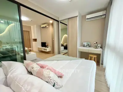 Modern bedroom with cozy decor and sliding glass doors to living area.