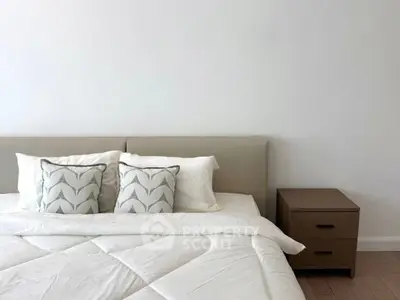 Modern bedroom with stylish bedding and wooden nightstand