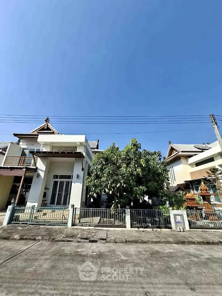 Charming suburban house with lush garden and traditional architectural design.