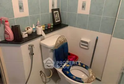 Cozy bathroom with unique decor and essential amenities.