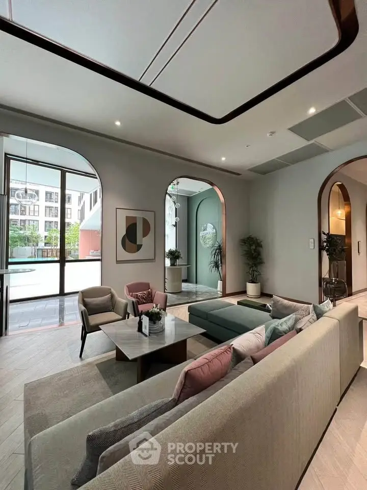 Luxurious modern living room with elegant decor and large windows offering a stunning view.