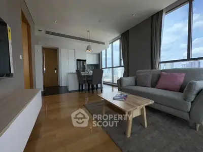 Spacious modern living room with city view and open kitchen layout.