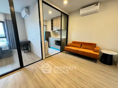 Modern apartment interior with open layout, featuring a cozy living area and stylish kitchen.