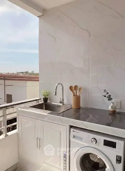 Modern balcony with washing machine and sink, perfect for urban living convenience.