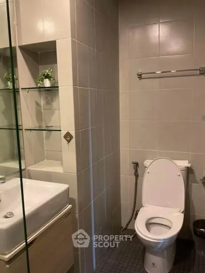 Modern bathroom with sleek fixtures and neutral tiles