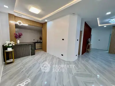 Modern open-layout living room with elegant lighting and sleek flooring