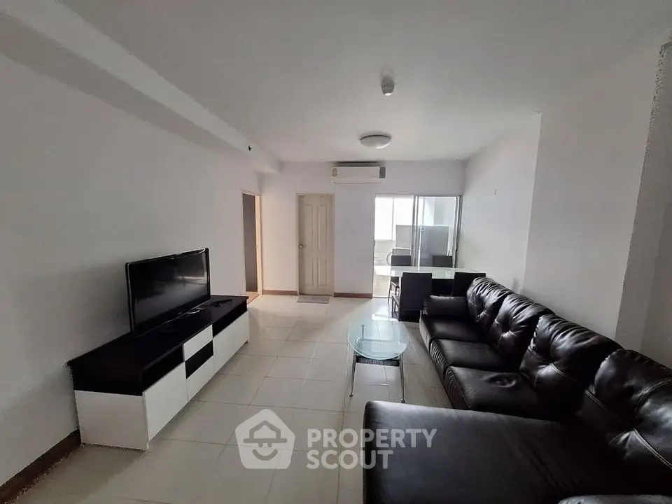 Spacious living room with modern leather sofa and sleek TV unit