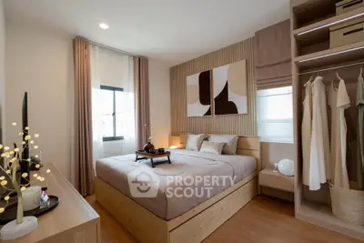 Modern bedroom with stylish decor and ample natural light, featuring a cozy bed and built-in wardrobe.