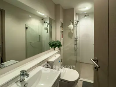 Modern bathroom with glass shower and sleek fixtures, ideal for contemporary living.