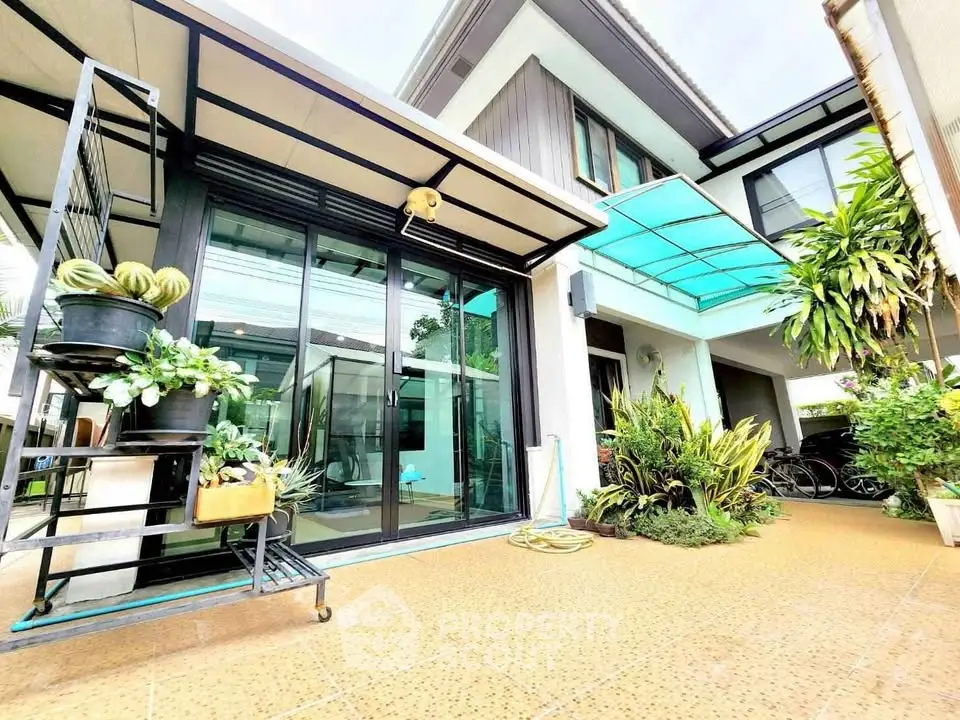 Modern home exterior with lush garden and large windows