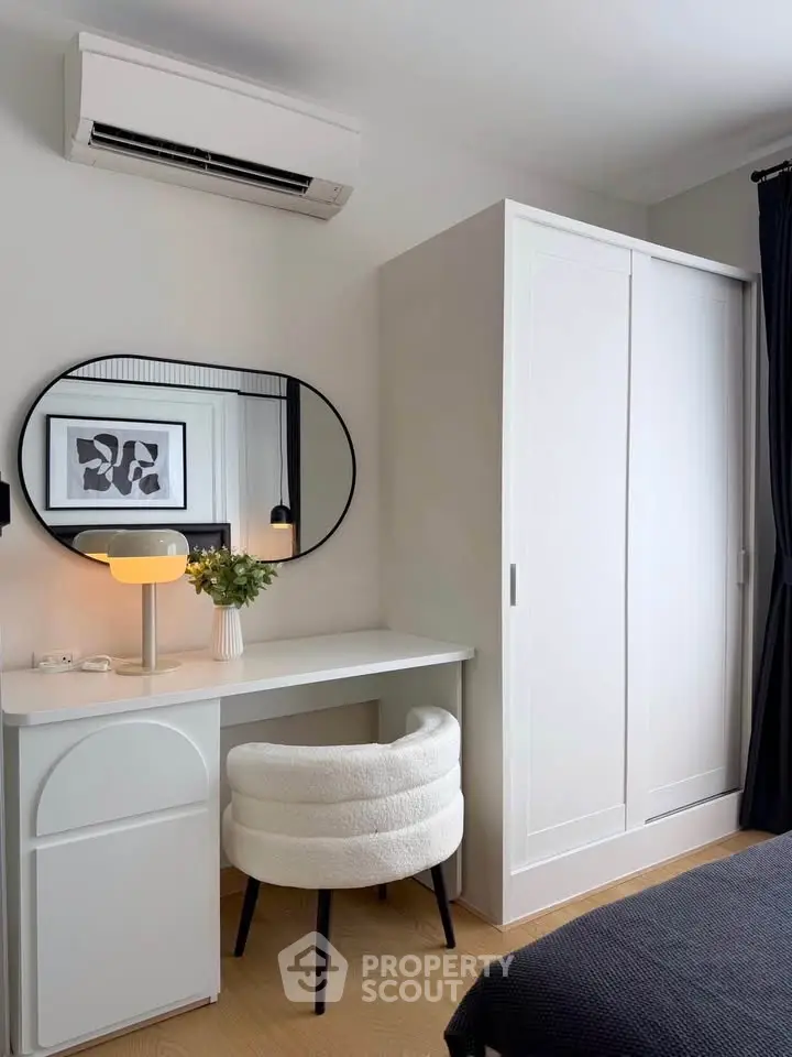 Chic bedroom with modern vanity, stylish chair, and sleek wardrobe.