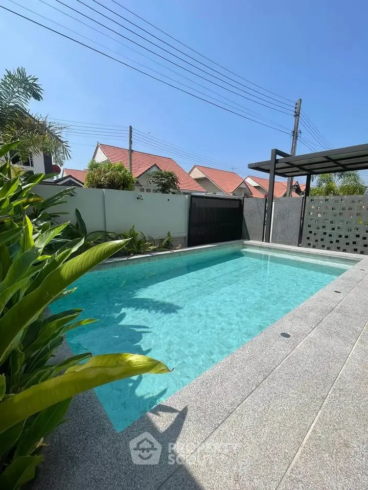 Stunning private pool with lush greenery and modern design in a serene residential area.