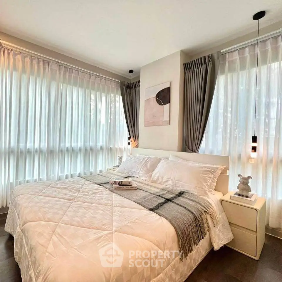 Luxurious bedroom with large windows and elegant decor, perfect for relaxation and comfort.