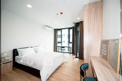 Spacious modern bedroom with large windows and stylish wooden furniture