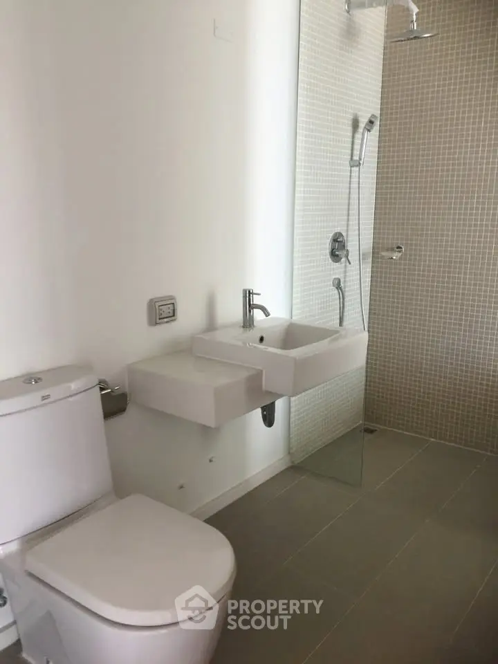 Modern bathroom with sleek fixtures and glass shower enclosure