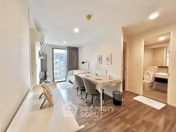 Modern studio apartment with open layout, featuring a cozy living area and stylish decor.