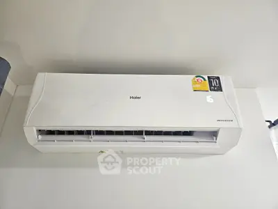 Modern wall-mounted air conditioner unit in a sleek interior setting.