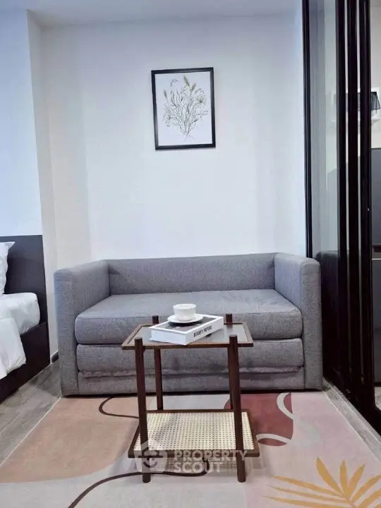 Modern living room with cozy gray sofa and stylish coffee table in a chic apartment.