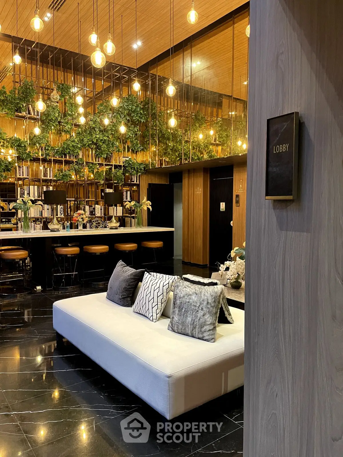 Luxurious modern lobby with elegant lighting and plush seating in a sophisticated setting.