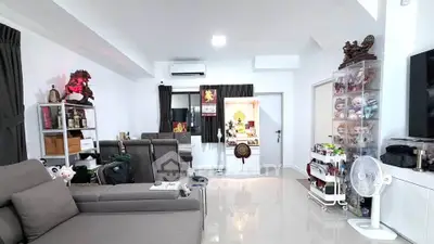 Spacious living room with modern decor and ample natural light