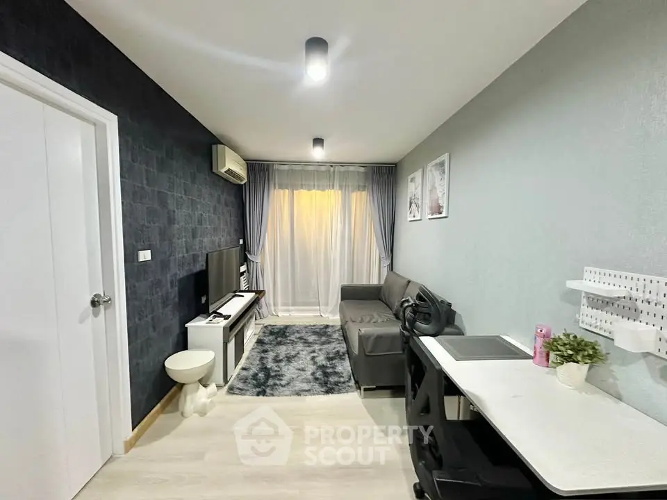 Modern living room with sleek furniture and stylish decor, featuring a cozy sofa and entertainment setup.