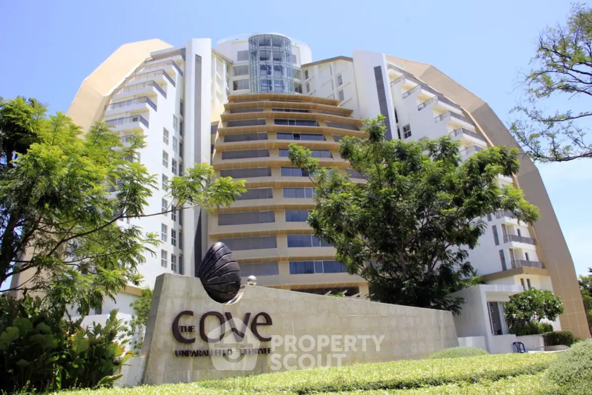 Luxurious modern building with unique architecture and lush greenery, ideal for upscale living.