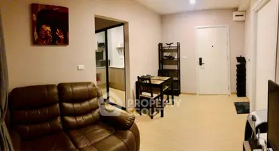 Cozy living room with leather sofa and dining area in modern apartment