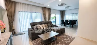Spacious modern living room with elegant dining area and large windows